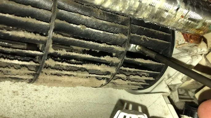 Fan wheel contamination requiring professional cleaning MVHR fan wheel coated in debris from lack of filtration in Sussex development