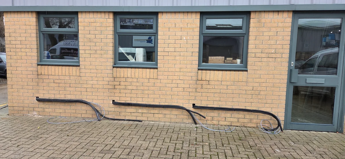 Exterior refrigerant pipework and electrical conduit installation for grow room cooling