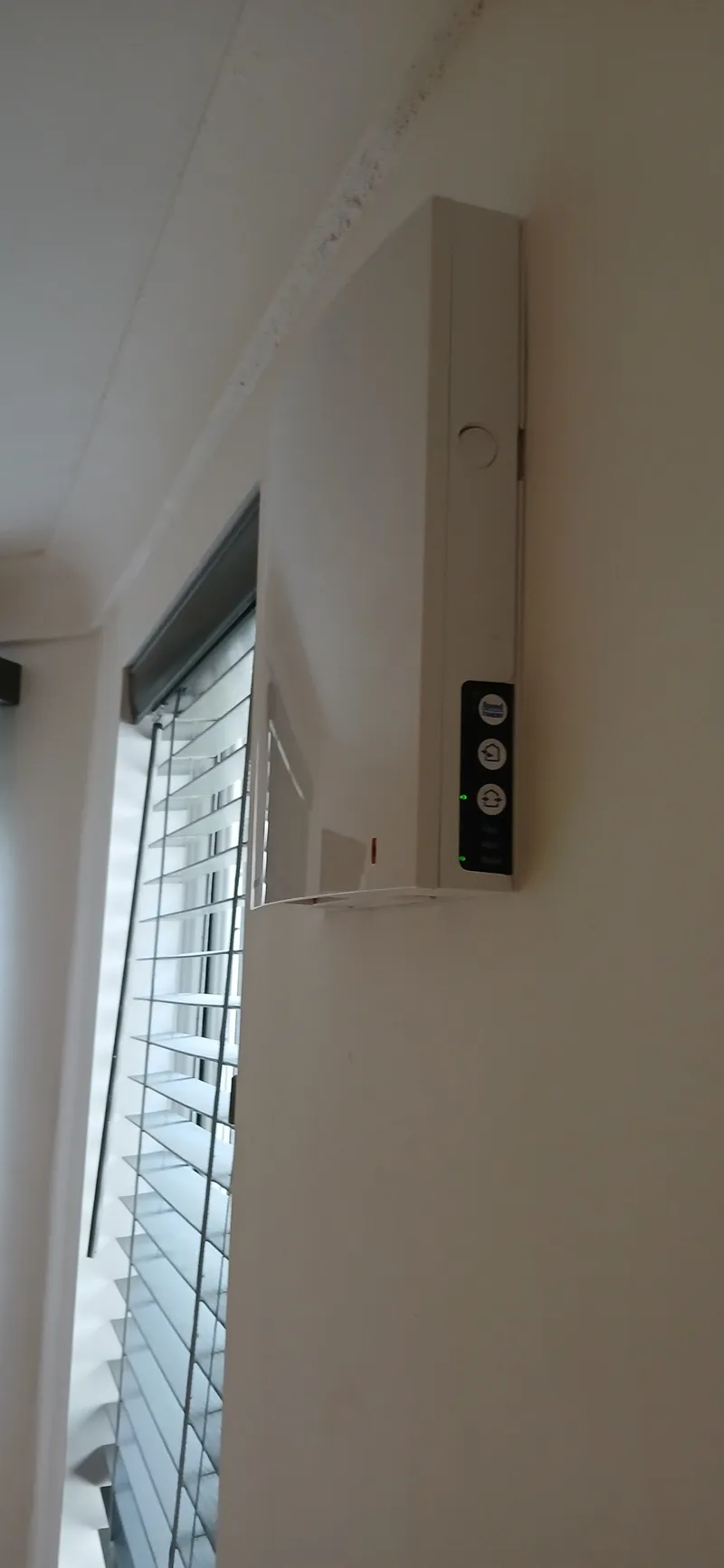 Wall-mounted dMVHR unit with ducting in Brighton basement flat installation